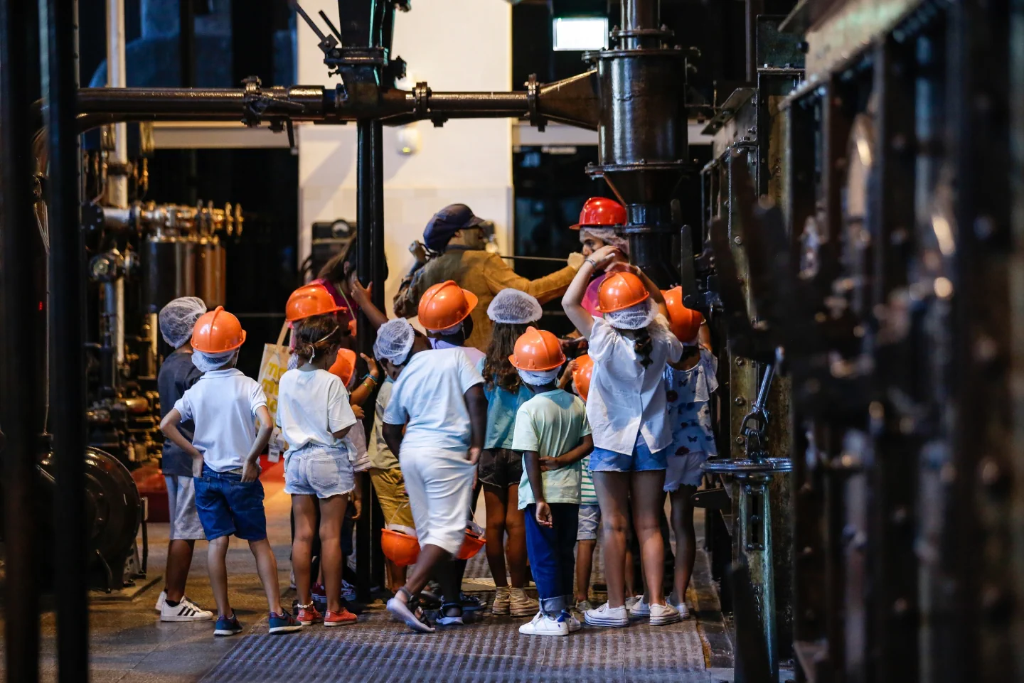 Children wearing hard hats during a guided visit inside Central Tejo