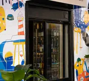 The tiled Locals and Nomads storefront and wine display in Graça