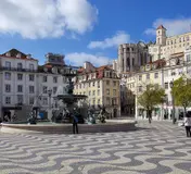 Rossio Square, its fountain and wave-patterned paving