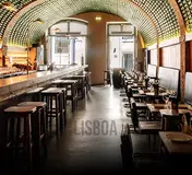 The bottle-lined ceiling and dining room of BytheWine in Lisbon