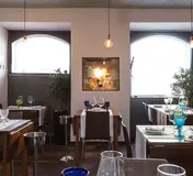 Tables, pendant lights and artwork inside Frade dos Mares