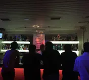 An archive photograph of the counter and guests inside Bar 106