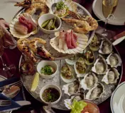 Oysters and seafood shared at a table at Rosamar