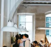 The bright high-ceilinged café interior at COMOBÅ