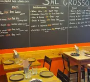 The chalkboard menu and colourful tables at Taberna Sal Grosso’s Alfama restaurant