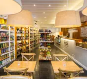 The shelves, counter and café tables at FOOD · Santos