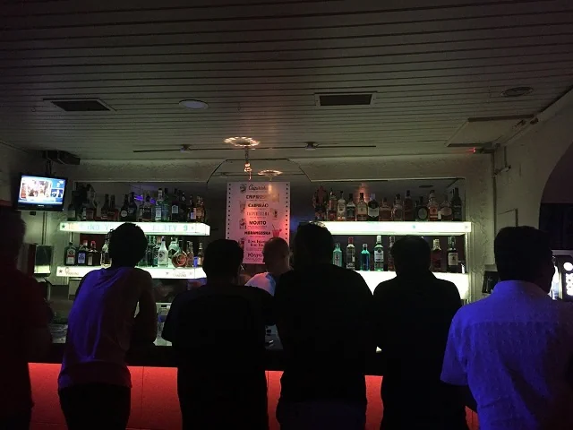 An archive photograph of the counter and guests inside Bar 106
