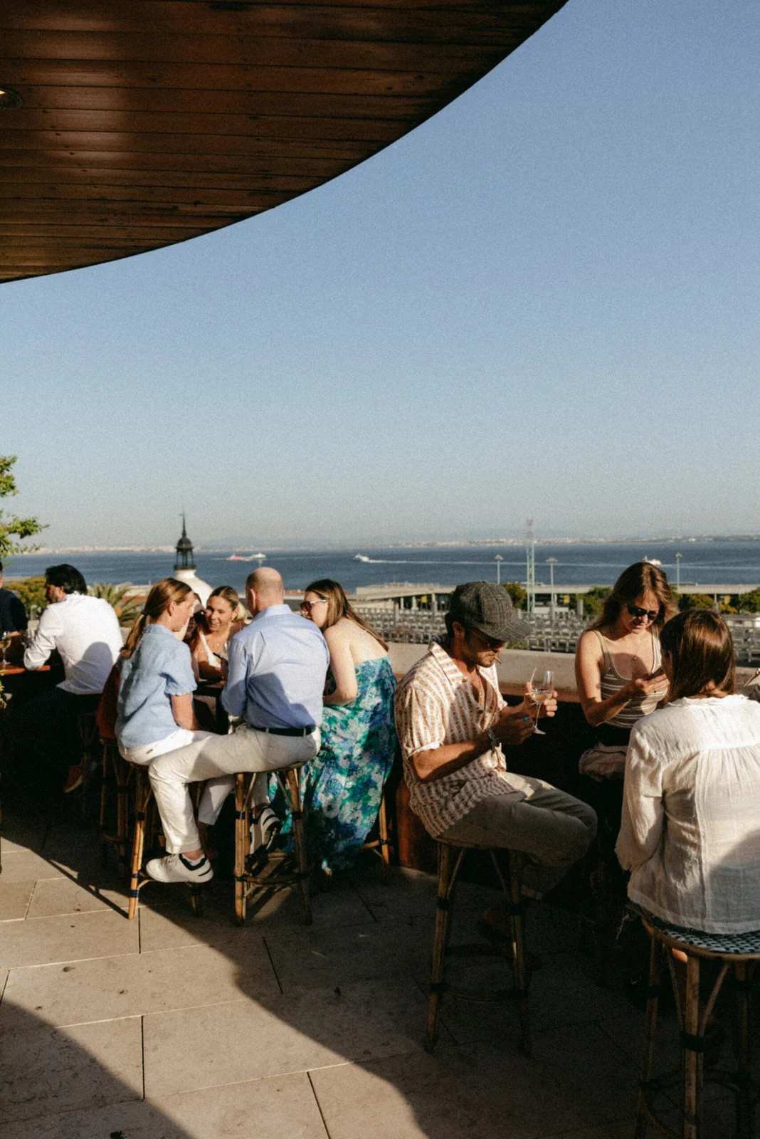 Guests on Javá’s rooftop terrace overlooking Lisbon