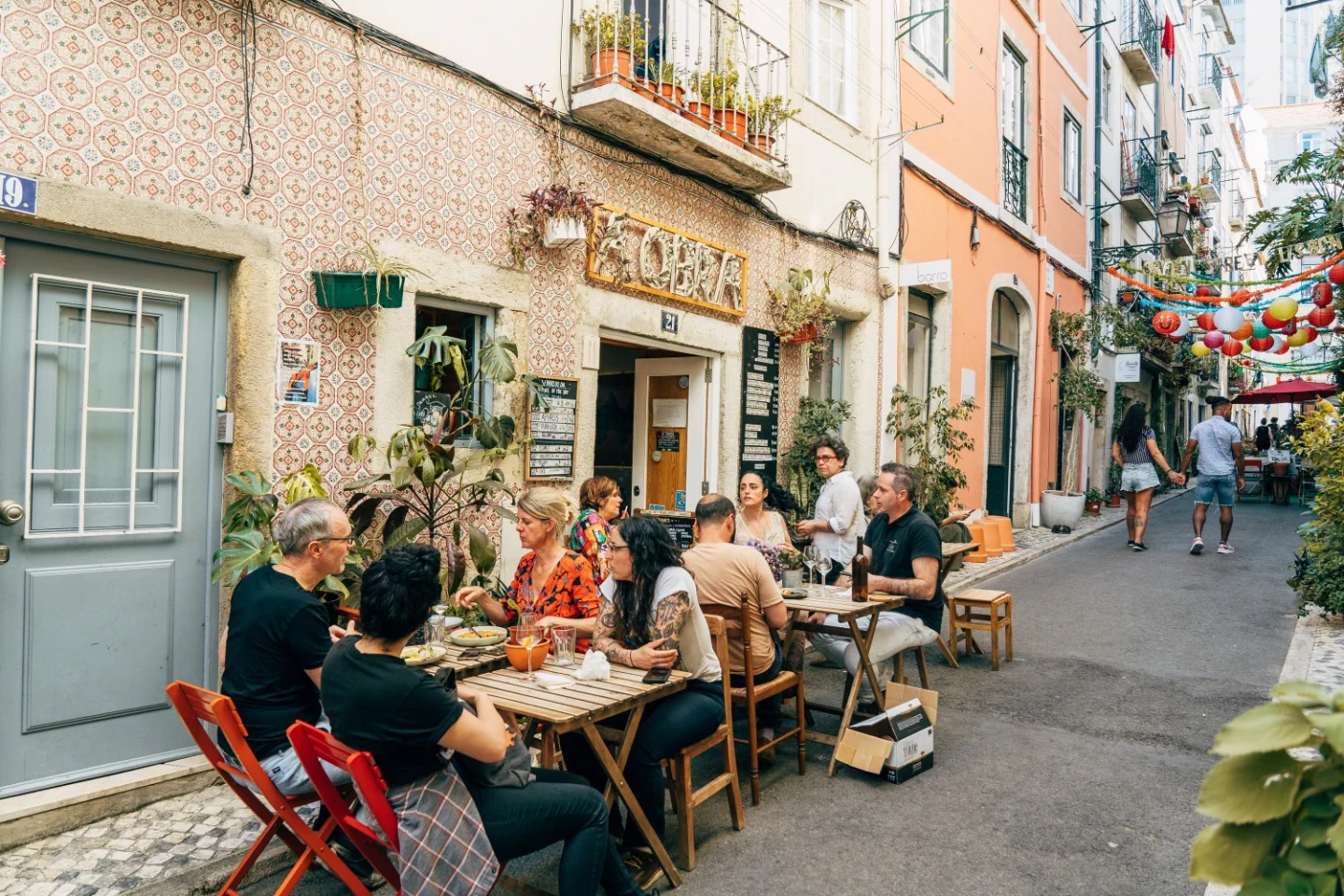 The tiled A Obra storefront and outdoor tables on Rua da Silva