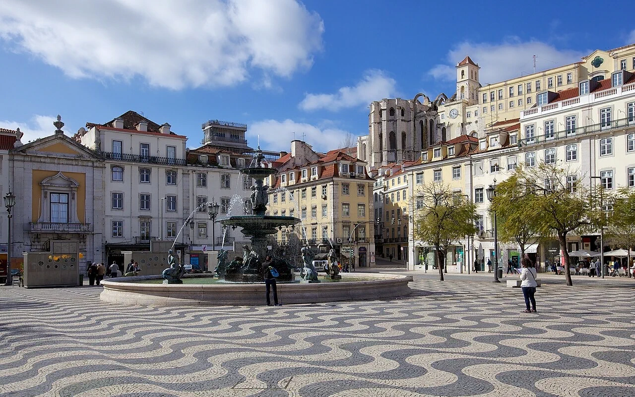 Rossio Square, its fountain and wave-patterned paving