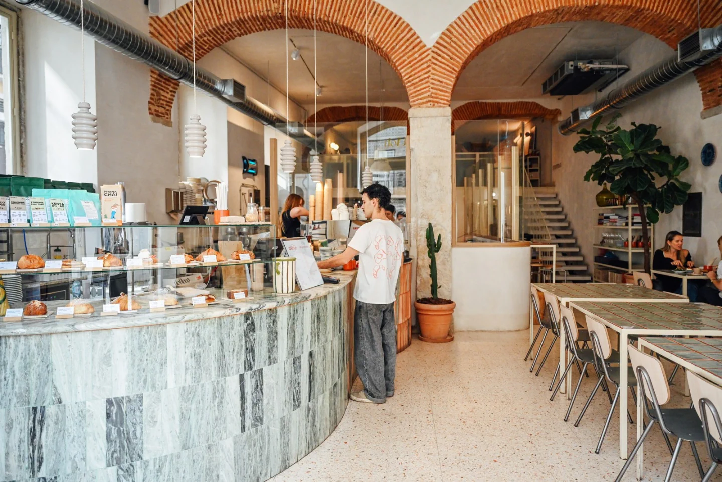 The pastry counter and bright dining room at Do Beco Santos