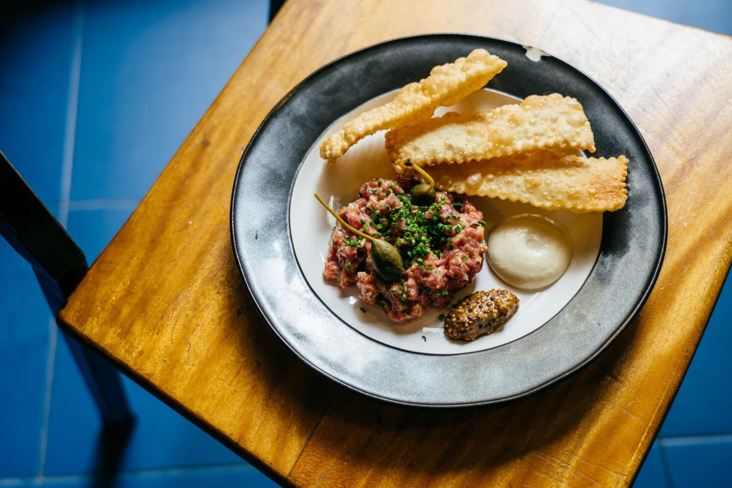 A plate of beef tartare and toasted bread at Tasca Baldracca