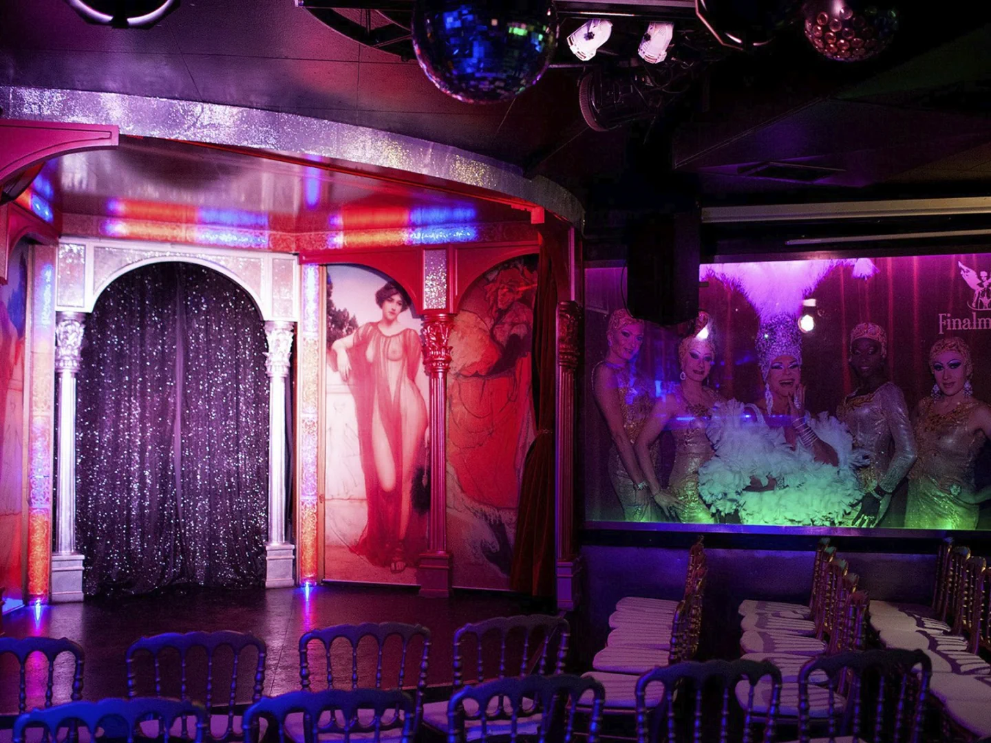 The small stage and purple-lit room inside Finalmente Club