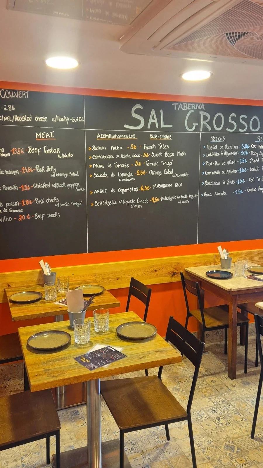 The chalkboard menu and colourful tables at Taberna Sal Grosso’s Alfama restaurant