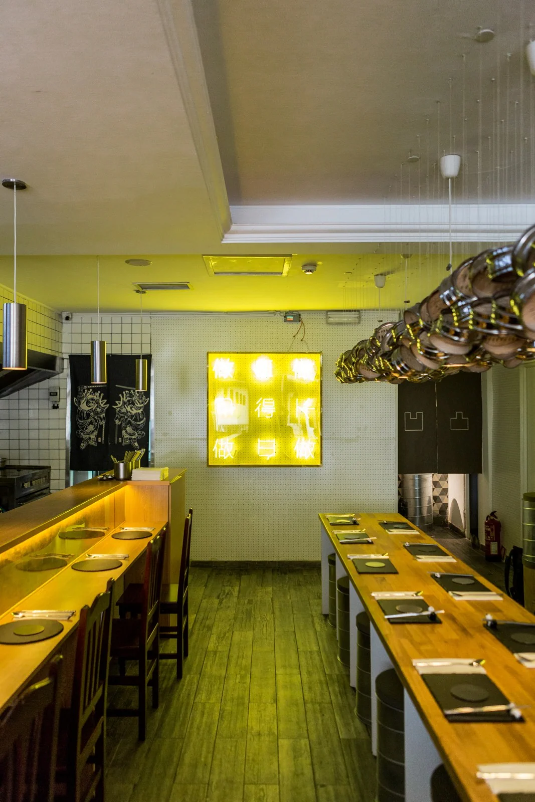 The yellow dining room and communal table at Panda Cantina