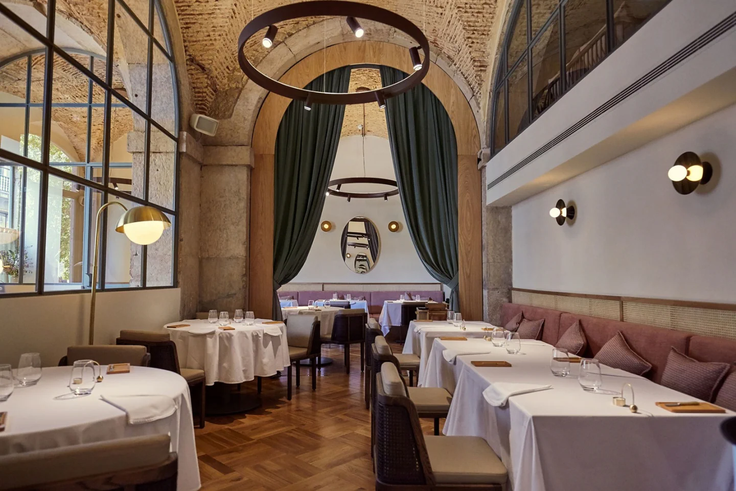 Tables, curved booths and large windows inside Belcanto