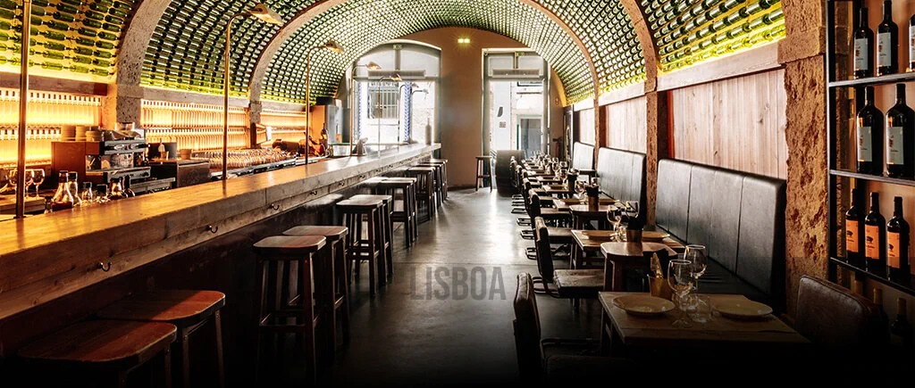 The bottle-lined ceiling and dining room of BytheWine in Lisbon