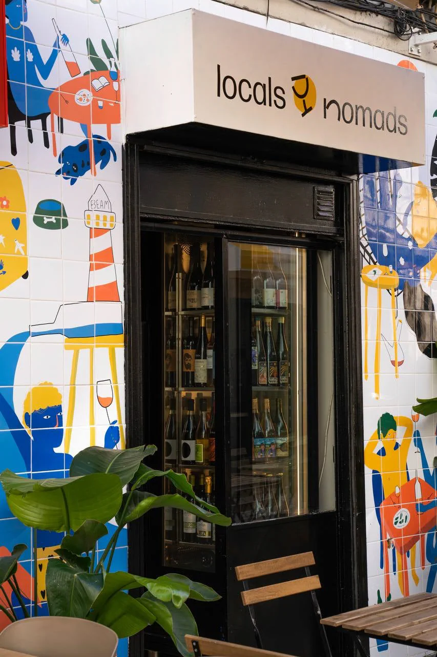 The tiled Locals and Nomads storefront and wine display in Graça