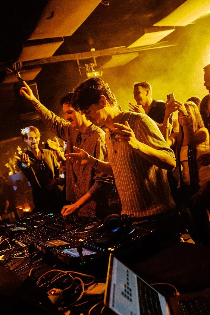 The DJ booth and yellow-lit crowd at K Urban Beach