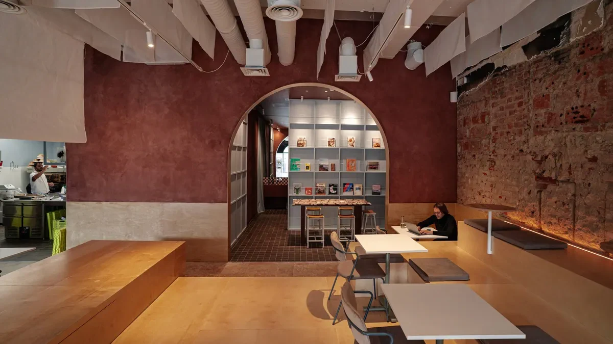 The arch, counter and tables inside TIMS · Santos